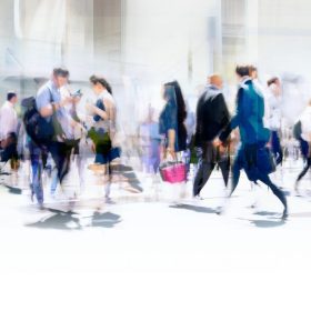 Walking people blur. Lots of people walking in the City of London. Wide panoramic view of people crossing the road.